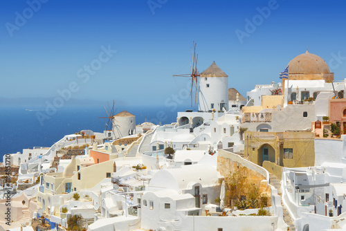 Oia village on Santorini island, Greece. Traditional and famous houses and windmill over the Caldera, Cyclades islands Aegean sea. photo