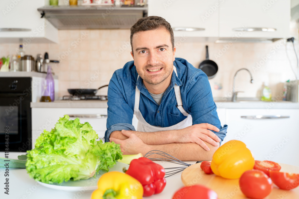 Man looking at the camera portrait in the kitchen at home Man looking at the camera portrait in the kitchen at home