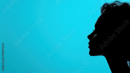 Silhouette of female profile against blue background