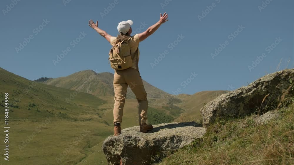 Woman hiker expressing joy while standing in mountains on sunny day. Woman hiker expressing joy while standing in mountains on sunny day.