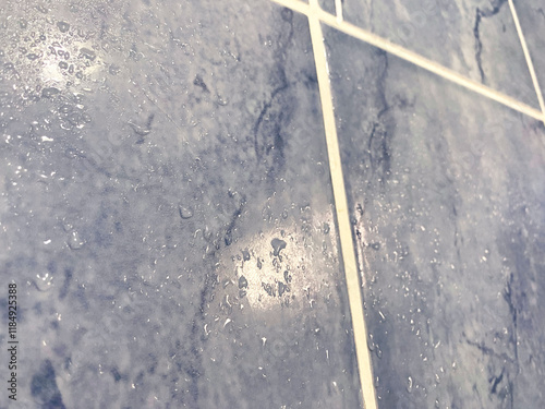 Water Droplets on Blue Tiles. Close-up of blue ceramic bathroom tiles with visible water droplets, showcasing moisture, condensation, and high humidity.