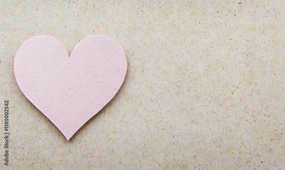 Obraz premium Pink paper heart on beige background.