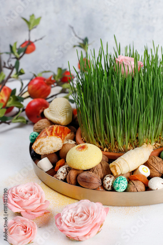 Traditional Azerbaijan holiday Novruz background with green semeni,traditional azerbaijan sweets,shekerbura,qogal,paxlava,mutaki and different nuts and sweets,top view,space for copy