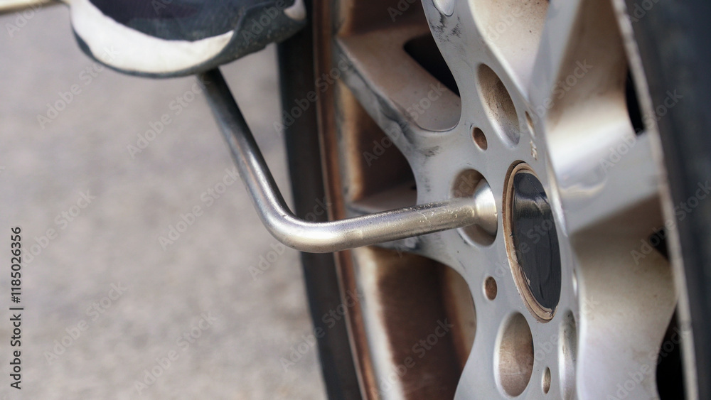 Mechanic changing a car wheel with lug wrench