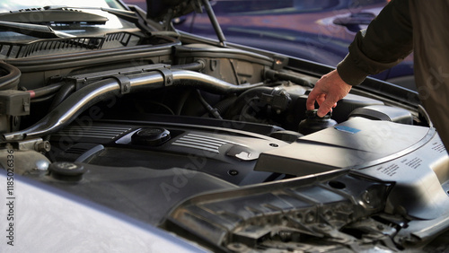 Mechanic checking car engine oil level