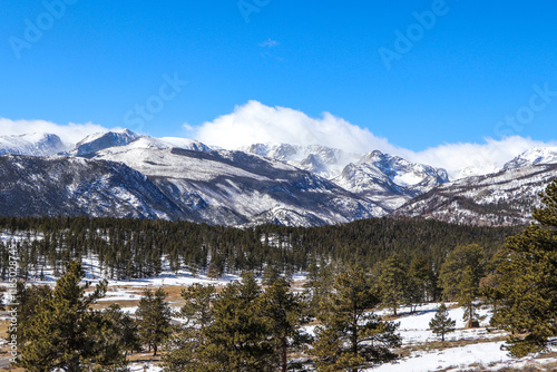 snowy mountain peaks in clouds at rocky mountain 