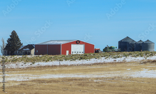 Red barn and grain silos on western farm.