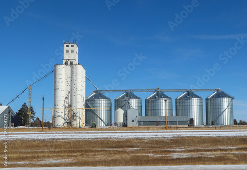 Agricultural grain elevator and storage bins on Colorado farm.
