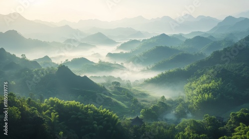 Mist-covered mountains at dawn create a serene landscape in the countryside with lush greenery