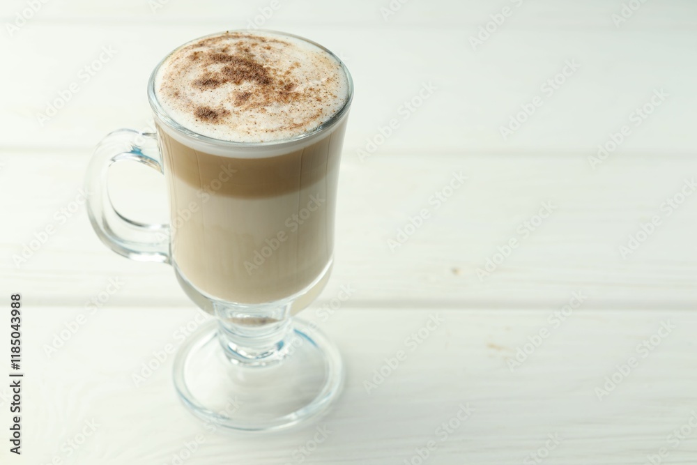 Tasty latte macchiato in glass cup on white wooden table, closeup. Space for text Tasty latte macchiato in glass cup on white wooden table, closeup. Space for text