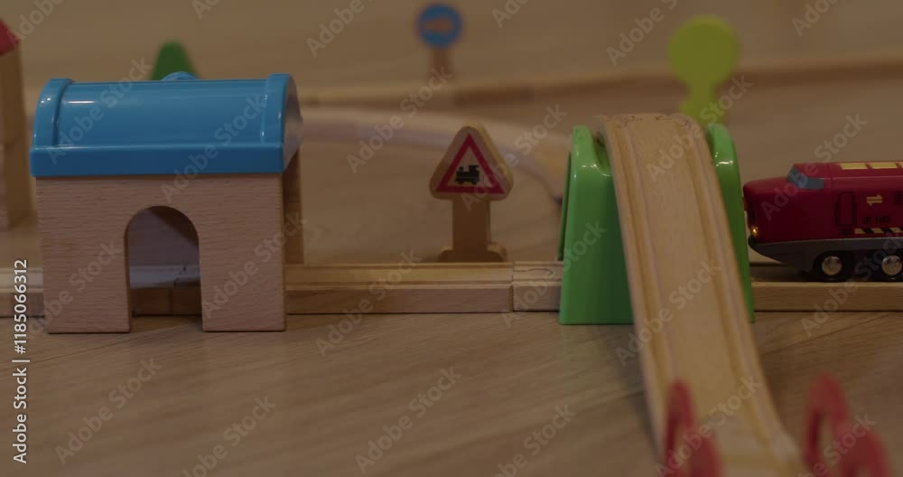 A colorful wooden train set with toy buildings and traffic signs, perfect for play