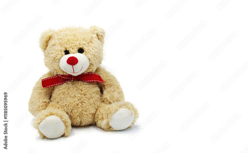Cute teddy bear doll for babies and children. Fluffy soft stuffed toy. isolated on white background with copy space. Beige yellow color with red nose and bow around neck.for a boy or girl child Cute teddy bear doll for babies and children. Fluffy soft stuffed toy. isolated on white background with copy space. Beige yellow color with red nose and bow around neck.for a boy or girl child