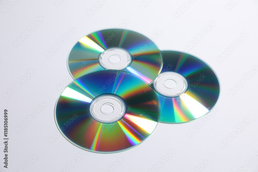 Many shiny compact discs on light background Many shiny compact discs on light background