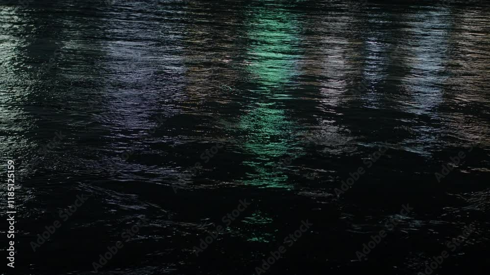 Nighttime urban landscape revealing mesmerizing city lights mirroring on rippling dark water surface, creating vibrant colorful reflective patterns Nighttime urban landscape revealing mesmerizing city lights mirroring on rippling dark water surface, creating vibrant colorful reflective patterns