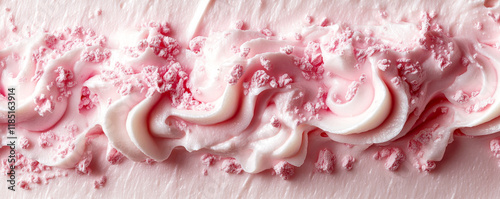 Pink buttercream icing swirls decorated with crushed candy on cake