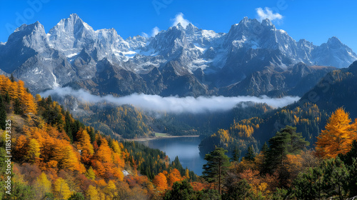 Majestic snow-capped mountains overlooking a tranquil autumn lake nestled in a vibrant forest