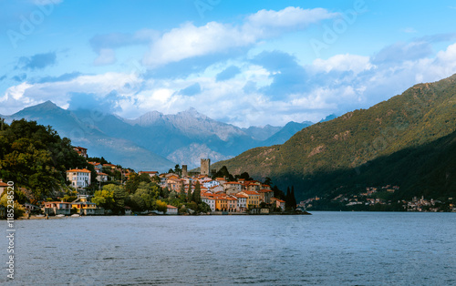 Lake Como offers a breathtaking view with colorful houses of Santa Maria Rezzonico nestled along the shore, backed by majestic mountains and a serene atmosphere, creating a picturesque scene in Lombar photo