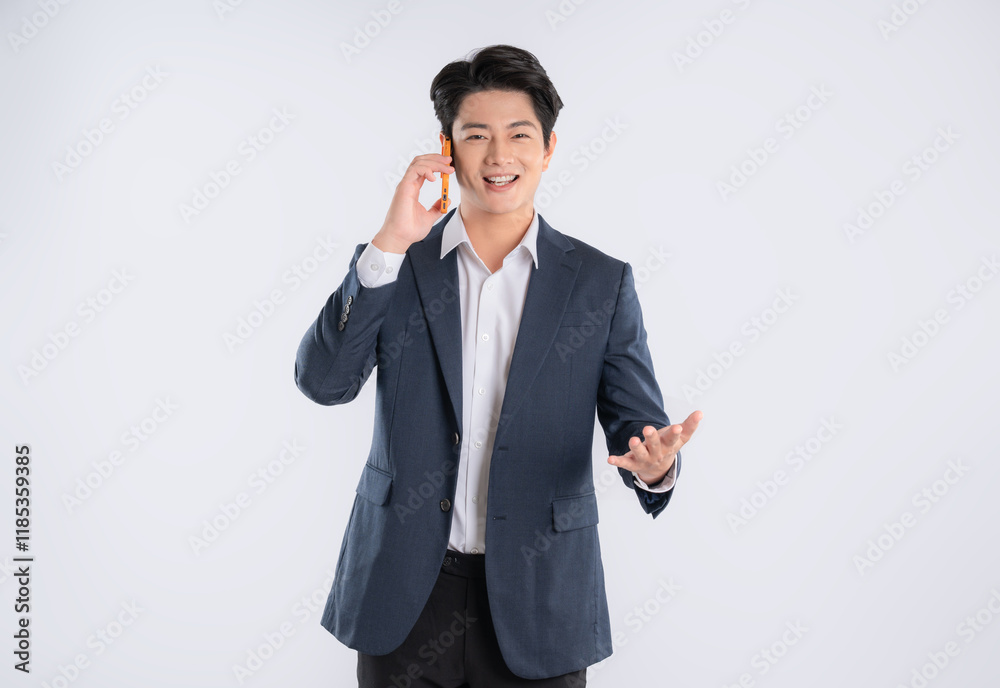 Portrait of young Asian business man using phone and posing on white background Portrait of young Asian business man using phone and posing on white background