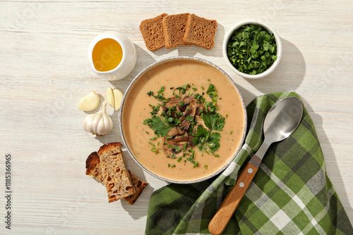 A bowl of cream of mushroom soup with parsley and croutons photo