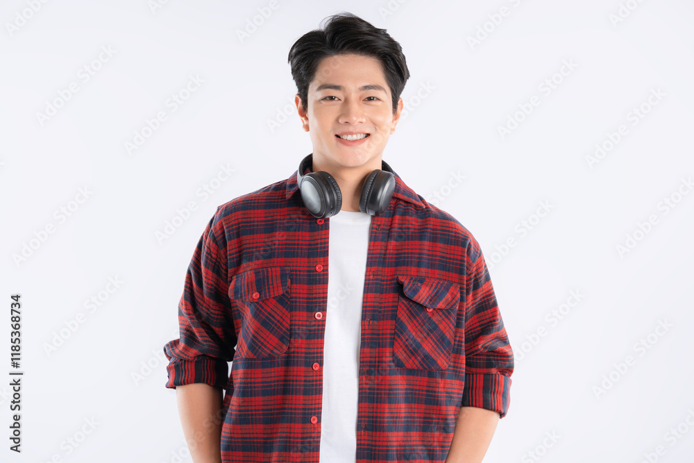Portrait of dynamic Asian guy wearing headphones and posing on white background
Portrait of dynamic Asian guy wearing headphones and posing on white background