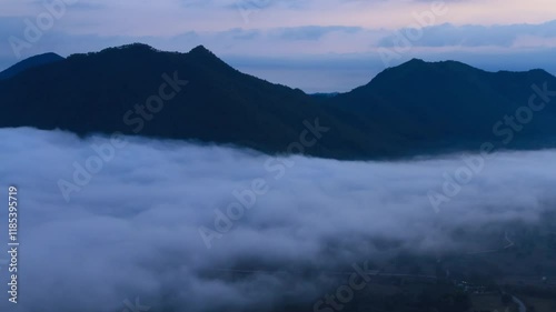 Very early morning landscape of mountain and sea of mist, Thailand. 4K 3840x2160, tilt down and wide shot. Can be establishing shot. Time lapse.