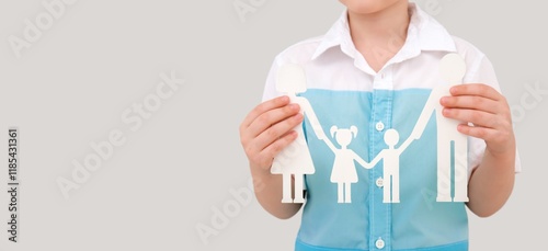 Child holding figures of fa...
