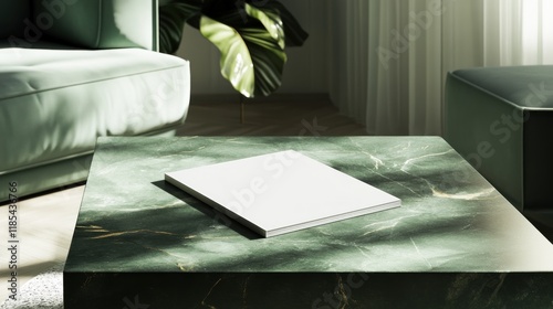 Blank book mockup on a green marble coffee table in a modern living room.