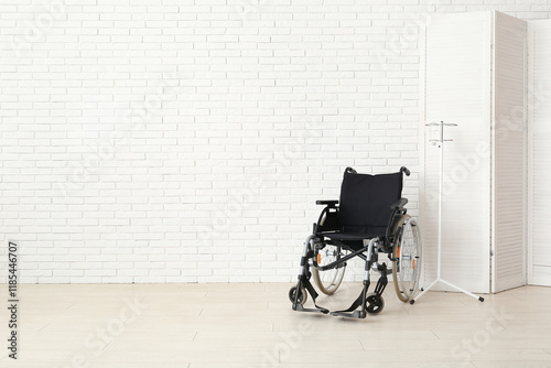 Empty wheelchair and IV pol...
