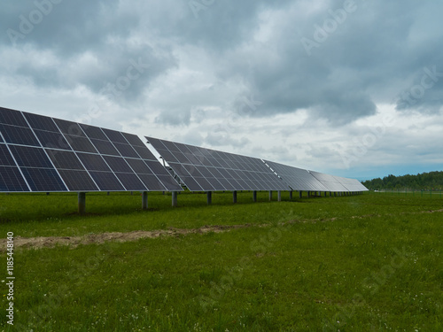 Solar panels in a field under a cloudy sky. Clean energy and renewable resources.