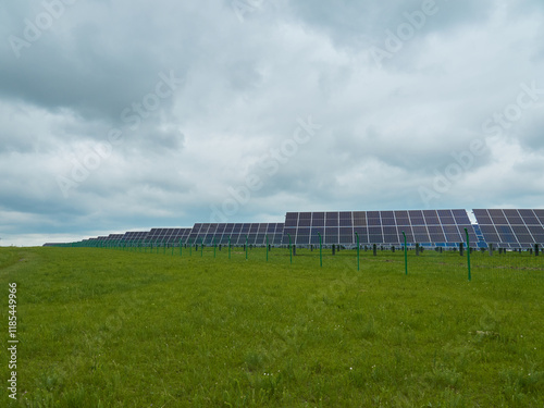 Solar panels in a field under a cloudy sky.  Clean energy source in a natural setting. photo