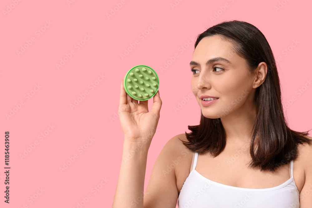 Beautiful young woman with hair scalp massager on pink background Beautiful young woman with hair scalp massager on pink background