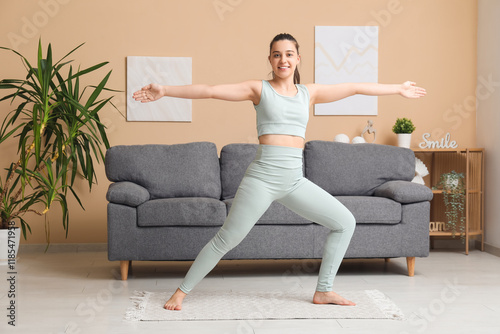 Sporty young woman doing yo...