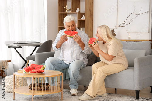 Mature couple eating waterm...