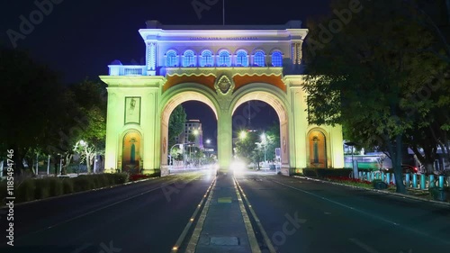 Guadalajara, Jalisco, México - Jan 8 2025: Night timelapse, , cars pass by. Majestic neoclassical arches built in 1942 in commemoration of the 400th anniversary of Guadalajara.