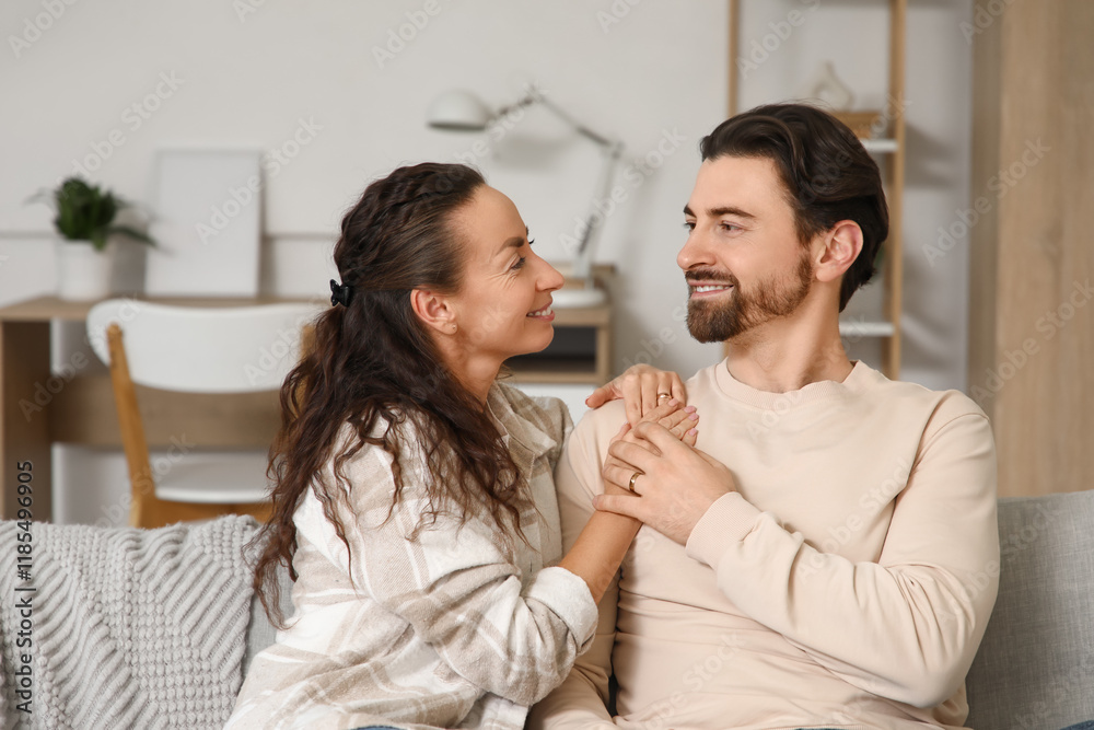 Married couple sitting on sofa at home Married couple sitting on sofa at home