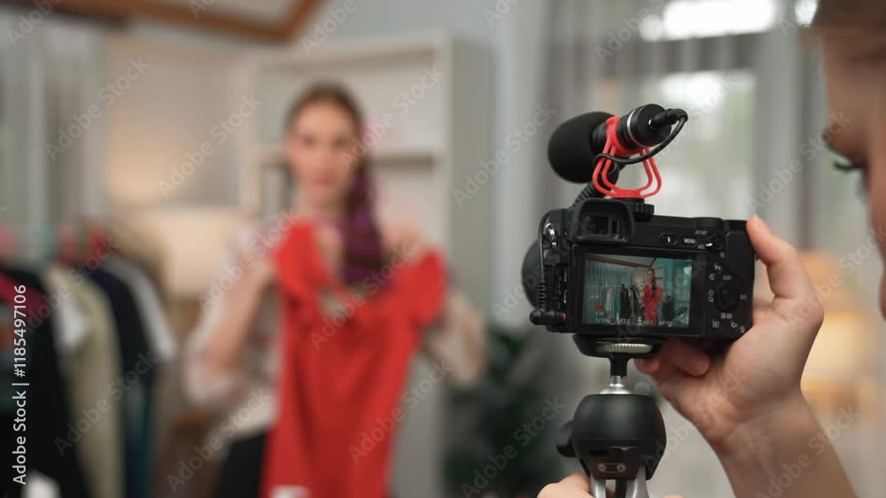 Two women influencer shoot live streaming vlog video review clothes prim social media or blog. Happy young girl with apparel studio lighting for marketing recording session broadcasting online.