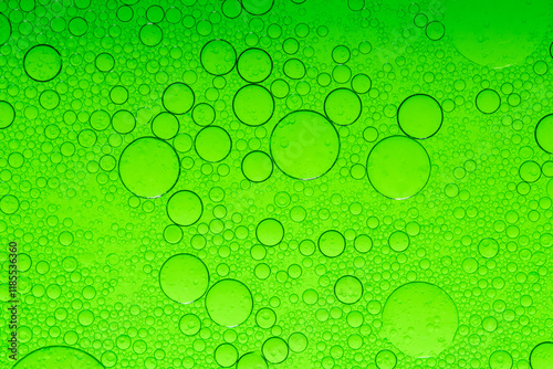 Macro microscope green bubble texture, Close-up Green bubbles and drops oil background . golden green water bubbles, close up golden oil drop for cosmetic