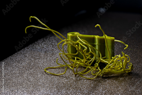 spaghetti failure on a 3D printer caused by high temperatures turning filament into a fluid state. photo