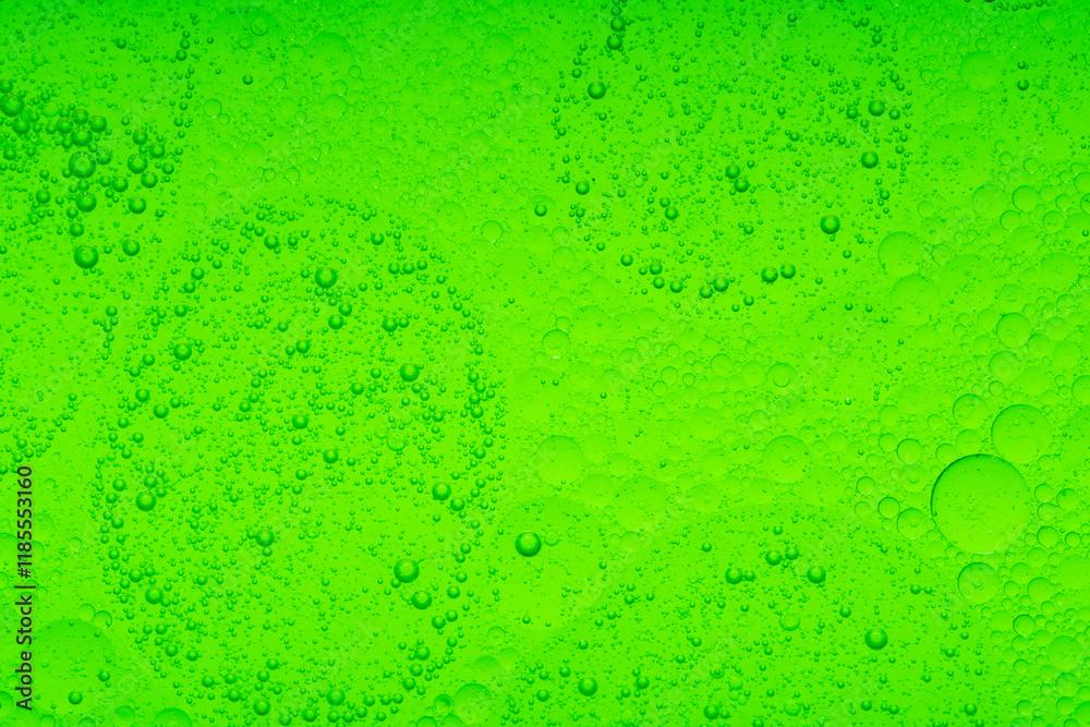 Macro microscope green bubble texture, Close-up Green bubbles and drops oil background . golden green water bubbles, close up golden oil drop for cosmetic Macro microscope green bubble texture, Close-up Green bubbles and drops oil background . golden green water bubbles, close up golden oil drop for cosmetic