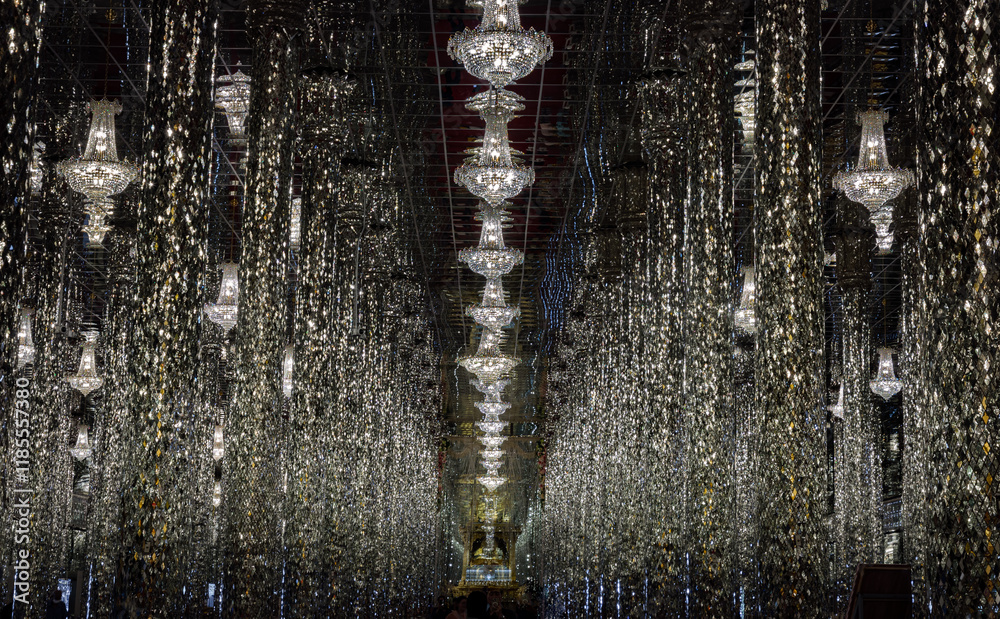 Interior decoration view of Chantaram temple (Wat Tha Sung) or The sung crystal temple with complex featuring an adorned with shiny, mirrored tiles & columns and Glittering ceiling lights. Copy space.