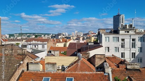 The camera pans over the rooftops of Belgrade on a sunny morning, capturing the cityscape under a clear blue sky in Serbia photo