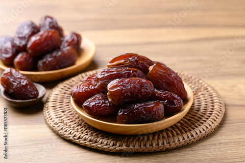 Date palm fruit (MedJool) on wooden plate
