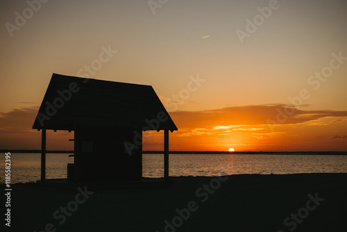 Coastal landscape at sunset. straw house at sunset
