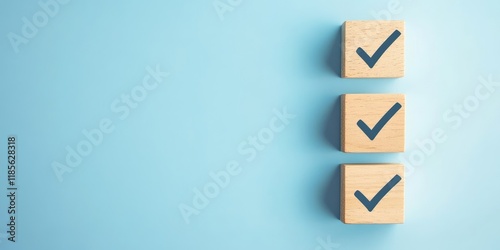 Three wooden blocks with a blue check mark on them photo