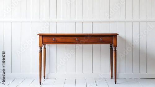 Elegant antique mahogany writing desk with a glossy finish showcased against a minimalist white wooden wall in a serene interior setting