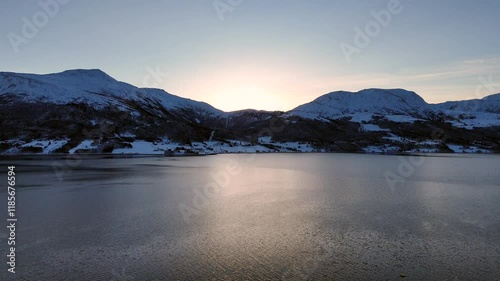 Aerial view of the snowy mountains surrounding Kvernes fjord between Averoeya and Gjemnes, Norway photo