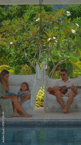 A Family Enjoying Reading Together by the Inviting Pool Amidst a Beautiful Garden Setting