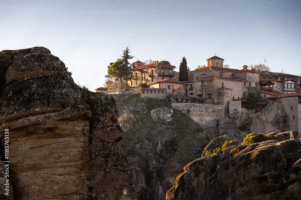 Fototapeta premium Meteora landscape. Holy Monastery of the Great Meteoron during a beautiful sunset. Travel to Greece Meteora to see the Greek Orthodox churches in the mountains.