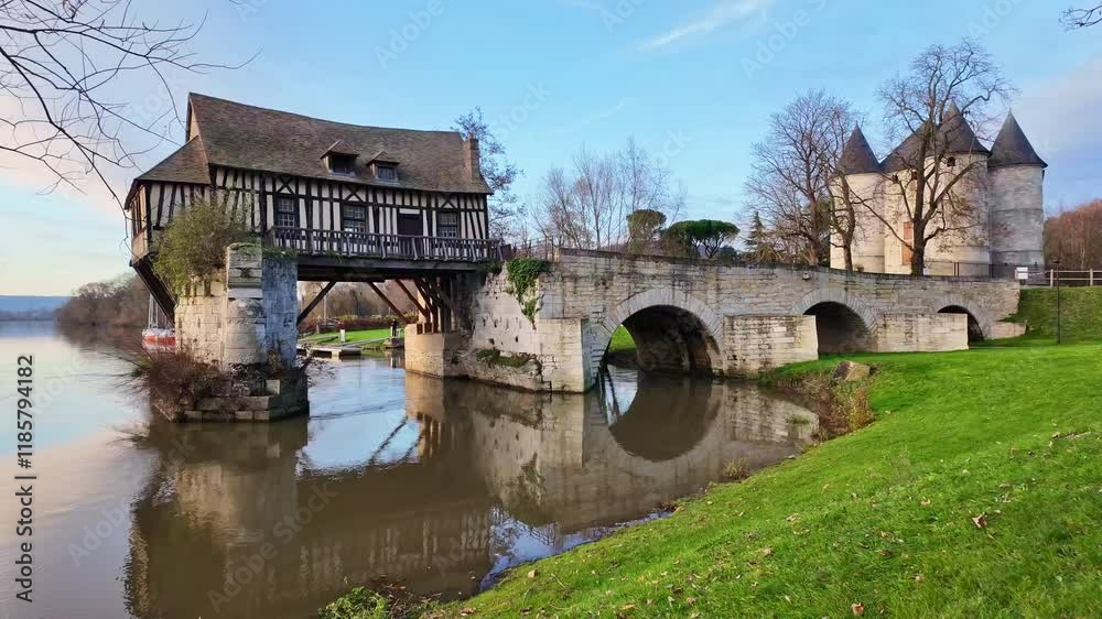Old mill on Seine River with Tourelles Castle in background, Vernon, Normandy in France Old mill on Seine River with Tourelles Castle in background, Vernon, Normandy in France