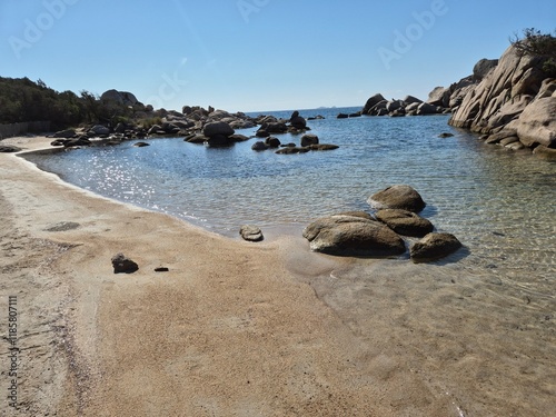 Plage de Tamaricciu, Spectacular seascape featuring turquoise water, rugged rocks, and smooth white sand at a beach in Porto Vecchio, South Corsica.